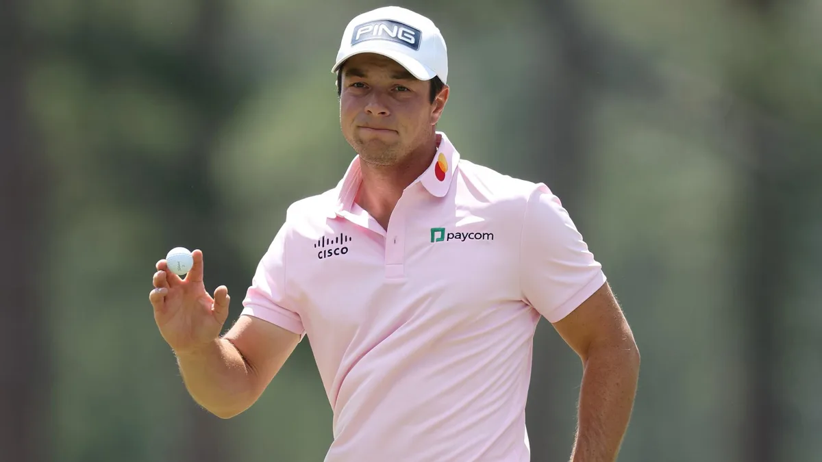Viktor Hovland holds up his ball after a birdie